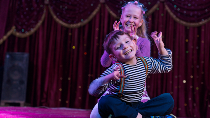 Kids in the middle of a performance on stage